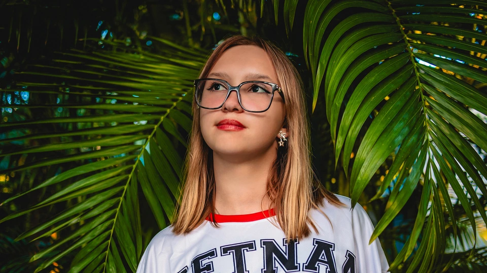 Portrait of a woman wearing glasses after glare removal and color correction